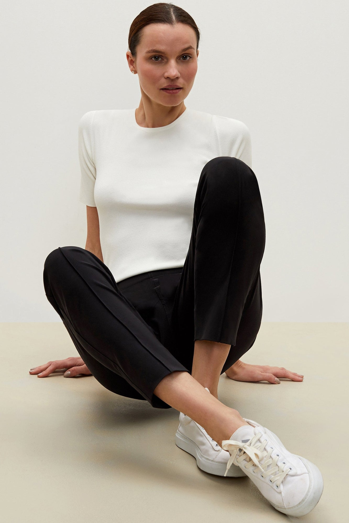 Front image of a woman sitting wearing the Colby Jogger in Black | Exclude