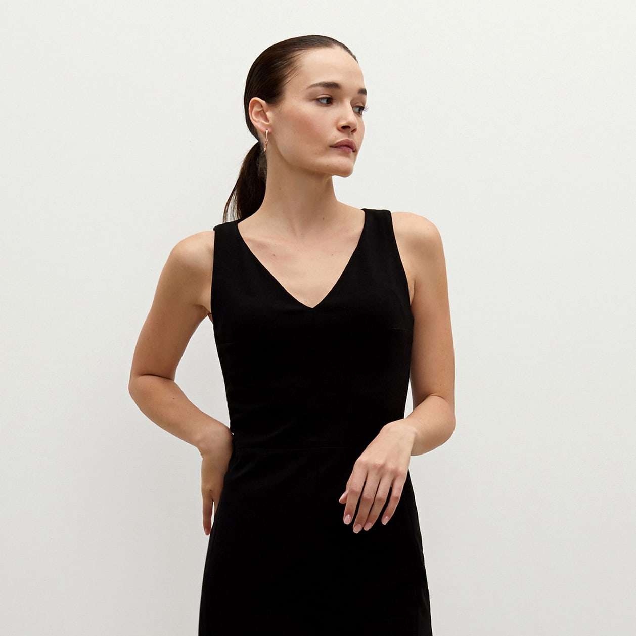 Front image of a woman standing wearing the Rachel dress in black | Exclude