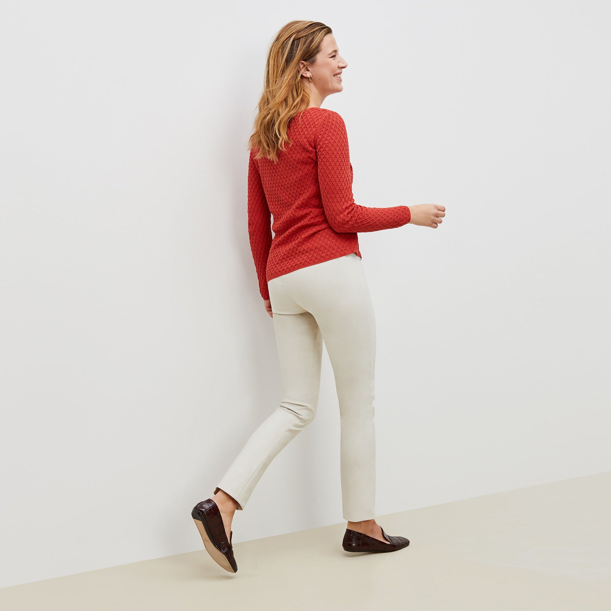 Back image of a woman standing wearing the foster pant in bone | Exclude