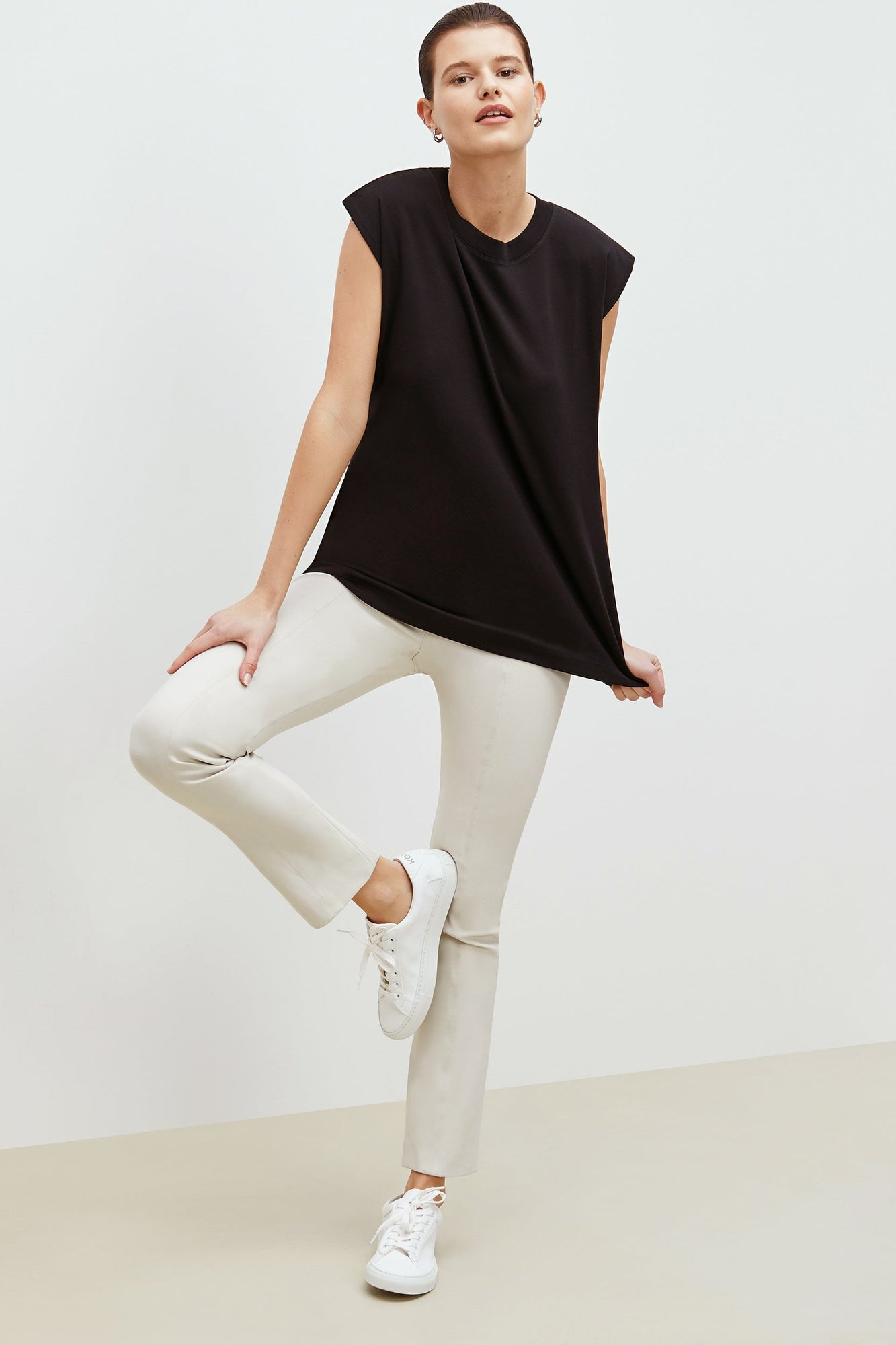 Front image of a woman standing wearing the foster pant in bone | Exclude
