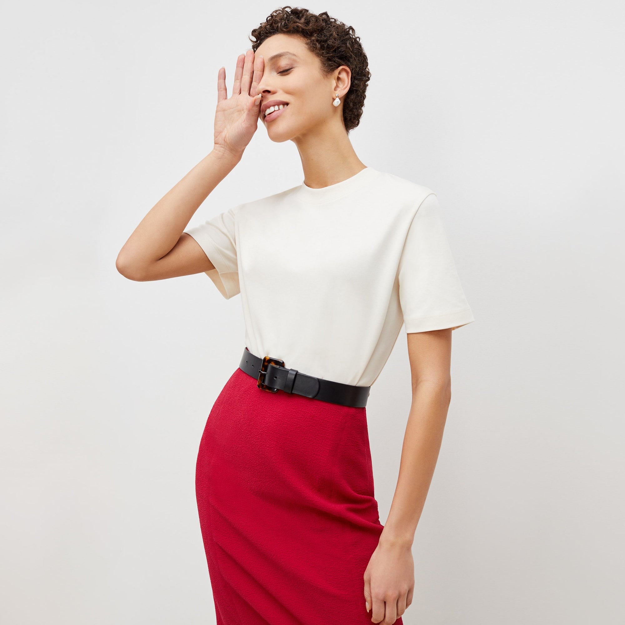 Front image of a woman standing wearing the leslie top in compact cotton in ivory | Exclude