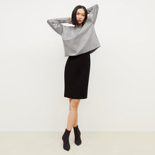 Front image of a woman standing wearing the Rachel dress in black