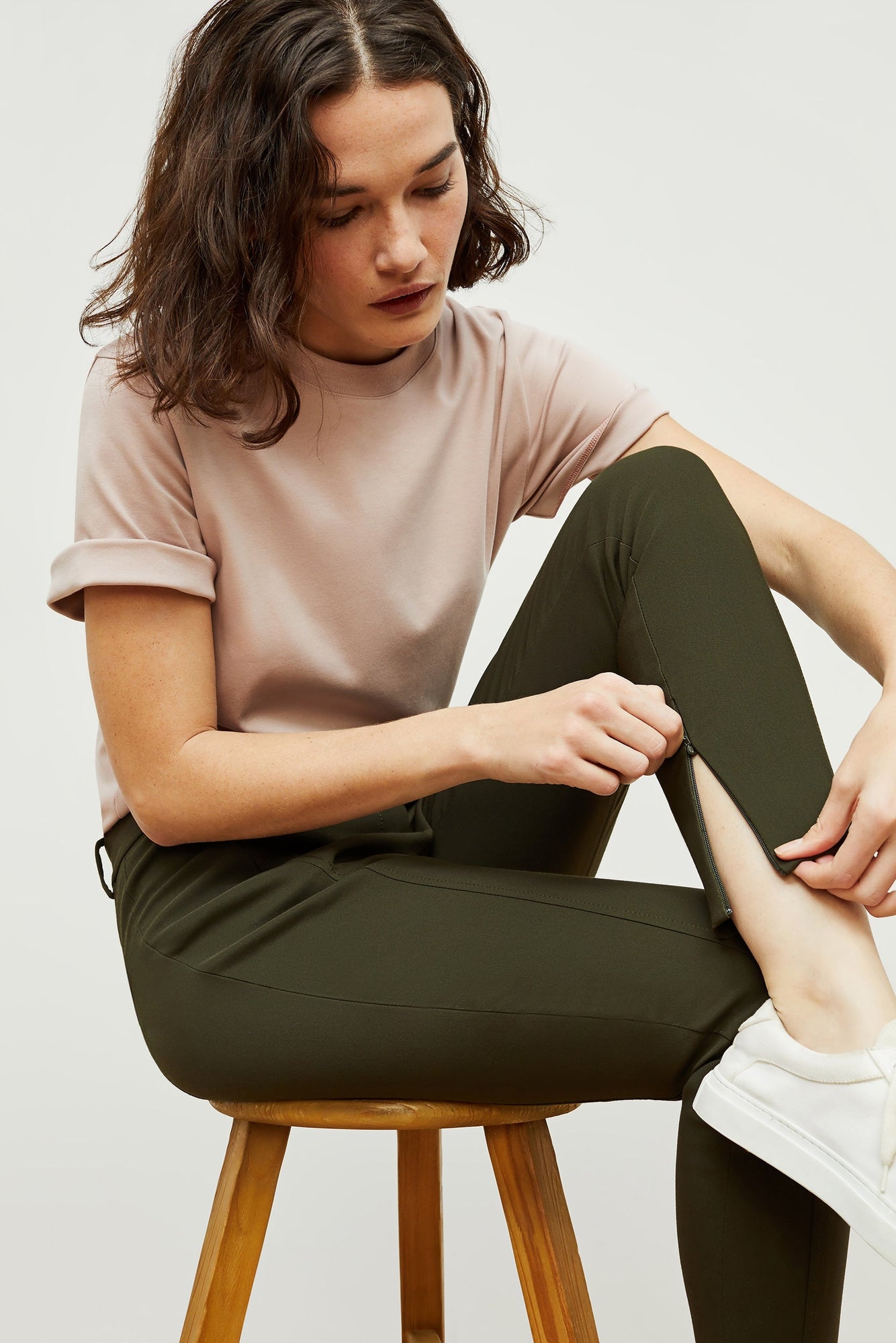 Detail image of a woman standing wearing the curie pant in dark olive | Exclude | Grid Hover