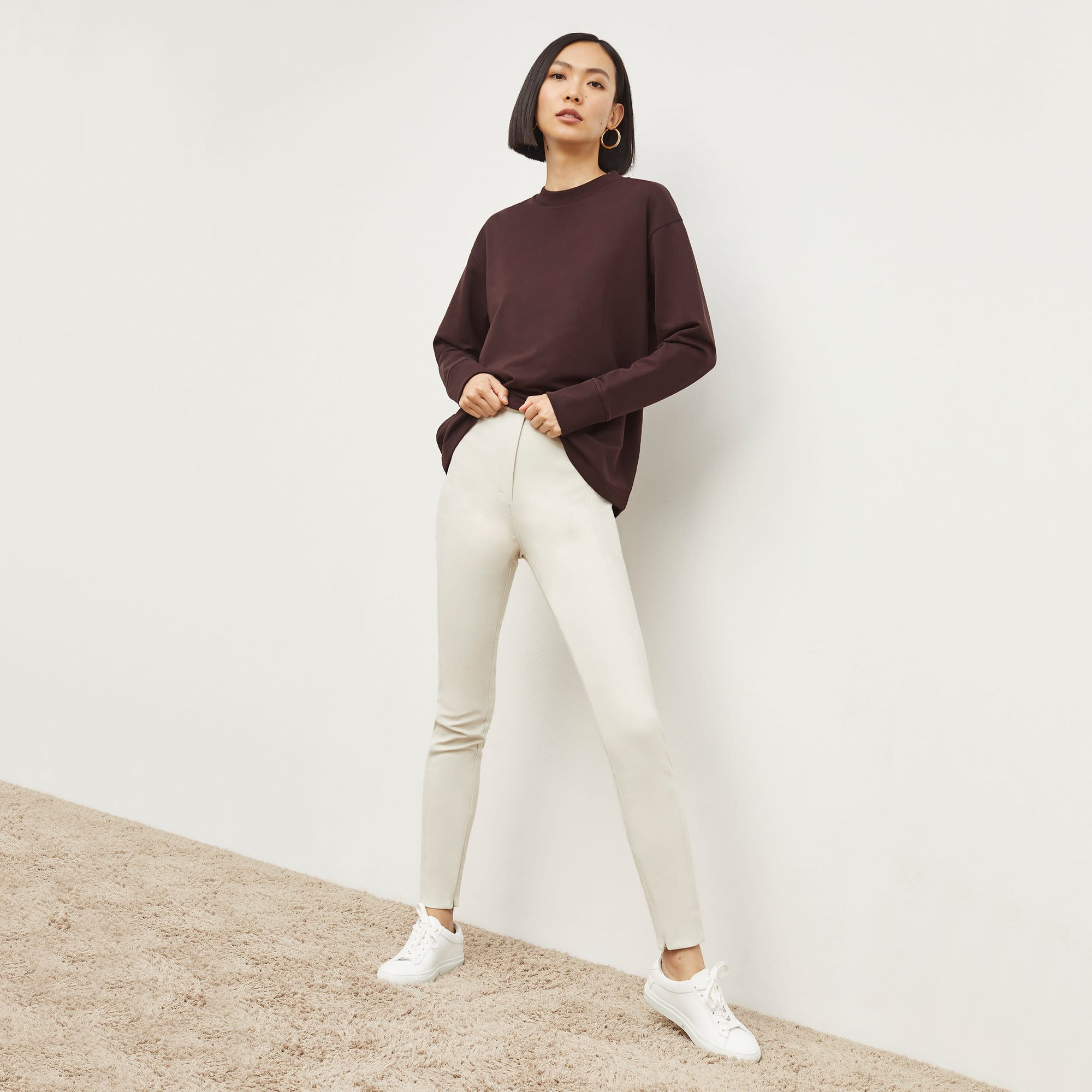 Front image of a woman standing wearing the Curie Pant—Everstretch in Bone | Exclude