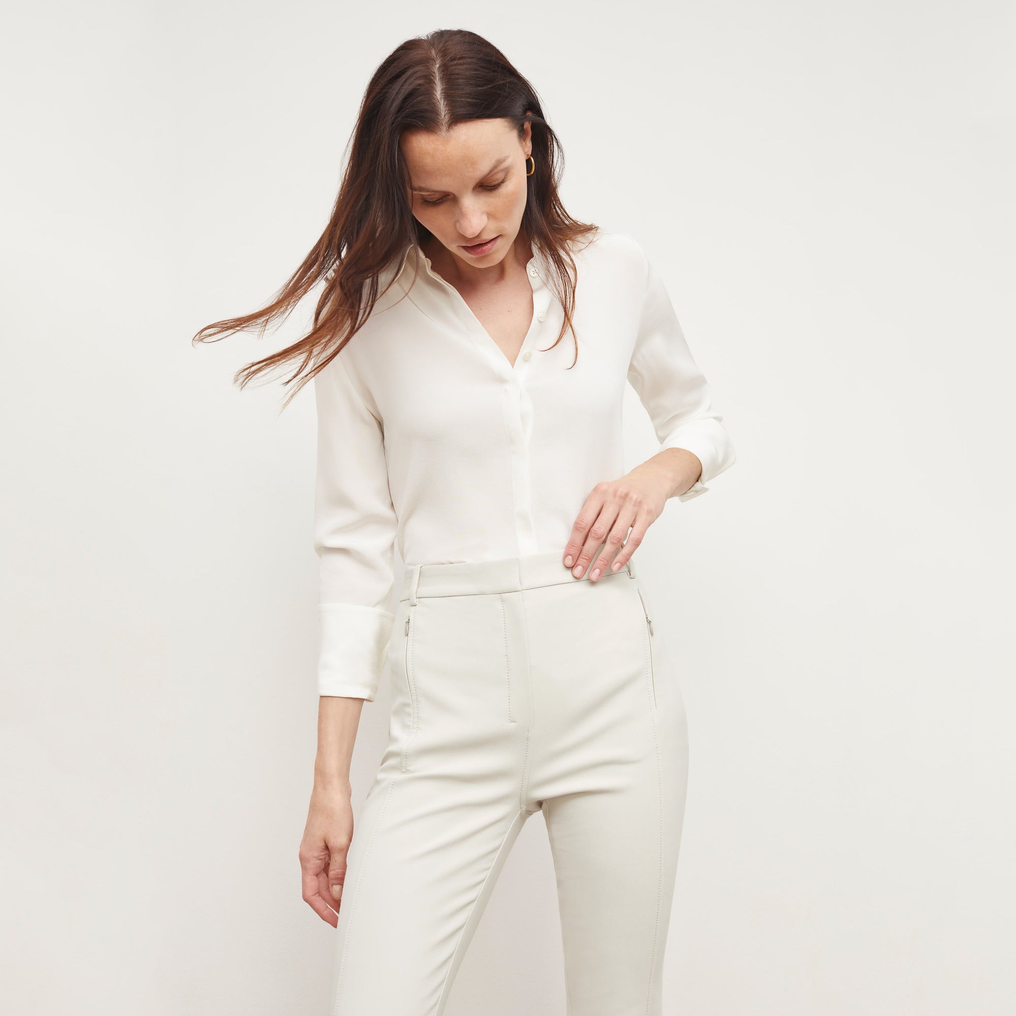 Front image of a woman standing wearing the Curie Pant—Everstretch in Bone | Exclude