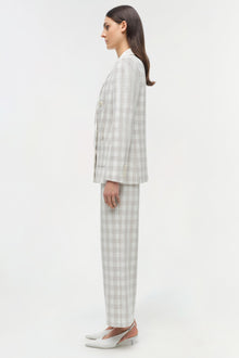 Light gray checked double-breasted blazer and matching trousers on model, shown in side profile.