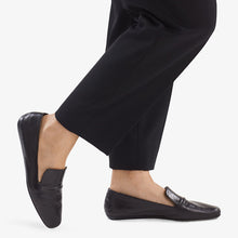 Side image of a woman standing wearing the Grace Loafer—Kidskin in Black