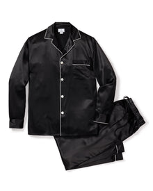 The Mens Silk Pajama Set in Black by Petite Plume is crafted from luxurious mulberry silk and features white piping. This set includes a long-sleeve button-up shirt with a chest pocket and matching elastic-waist pants, combining elegance and comfort effortlessly.
