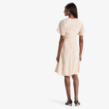 Back image of a woman standing wearing the Jessica Dress in ballet