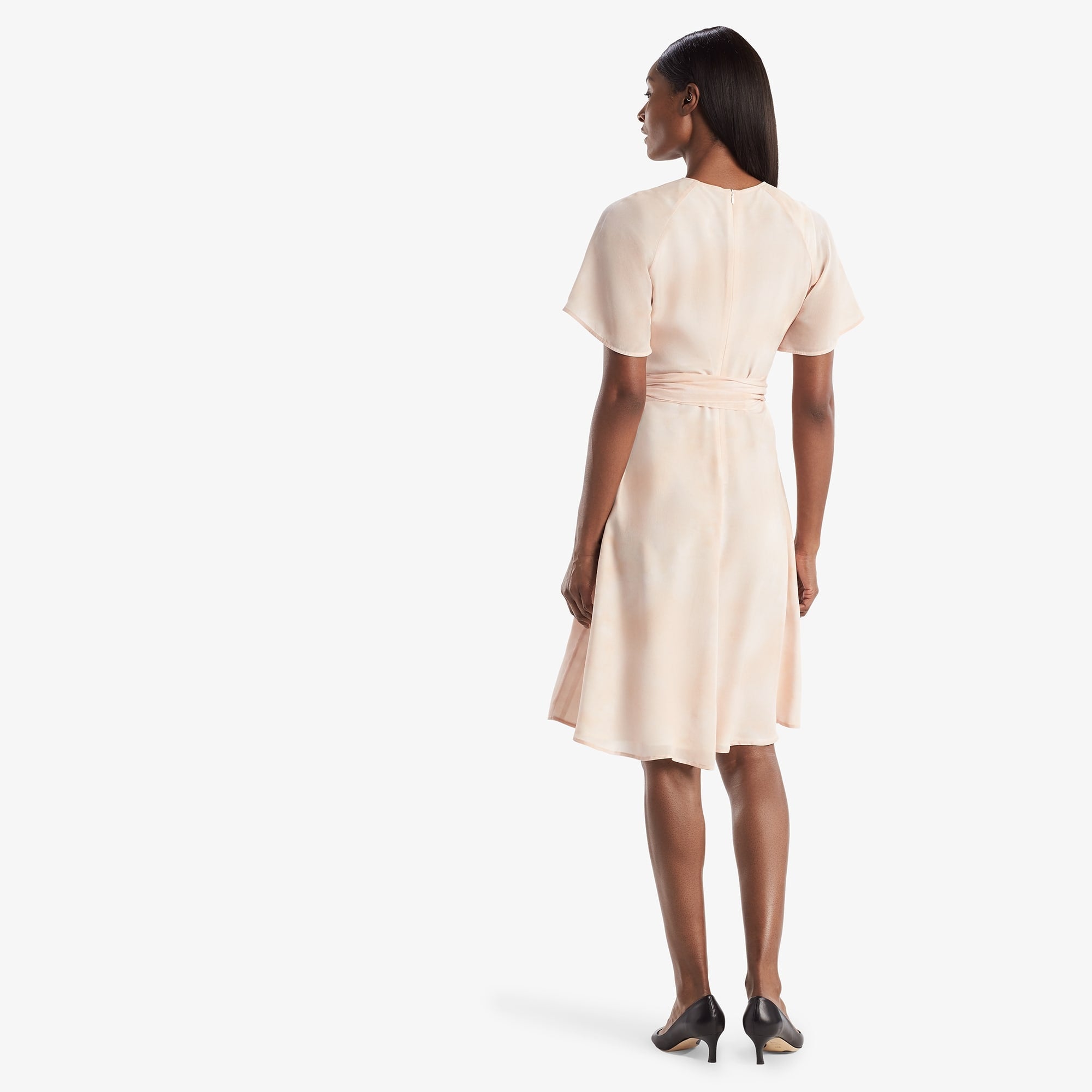 Back image of a woman standing wearing the Jessica Dress in ballet