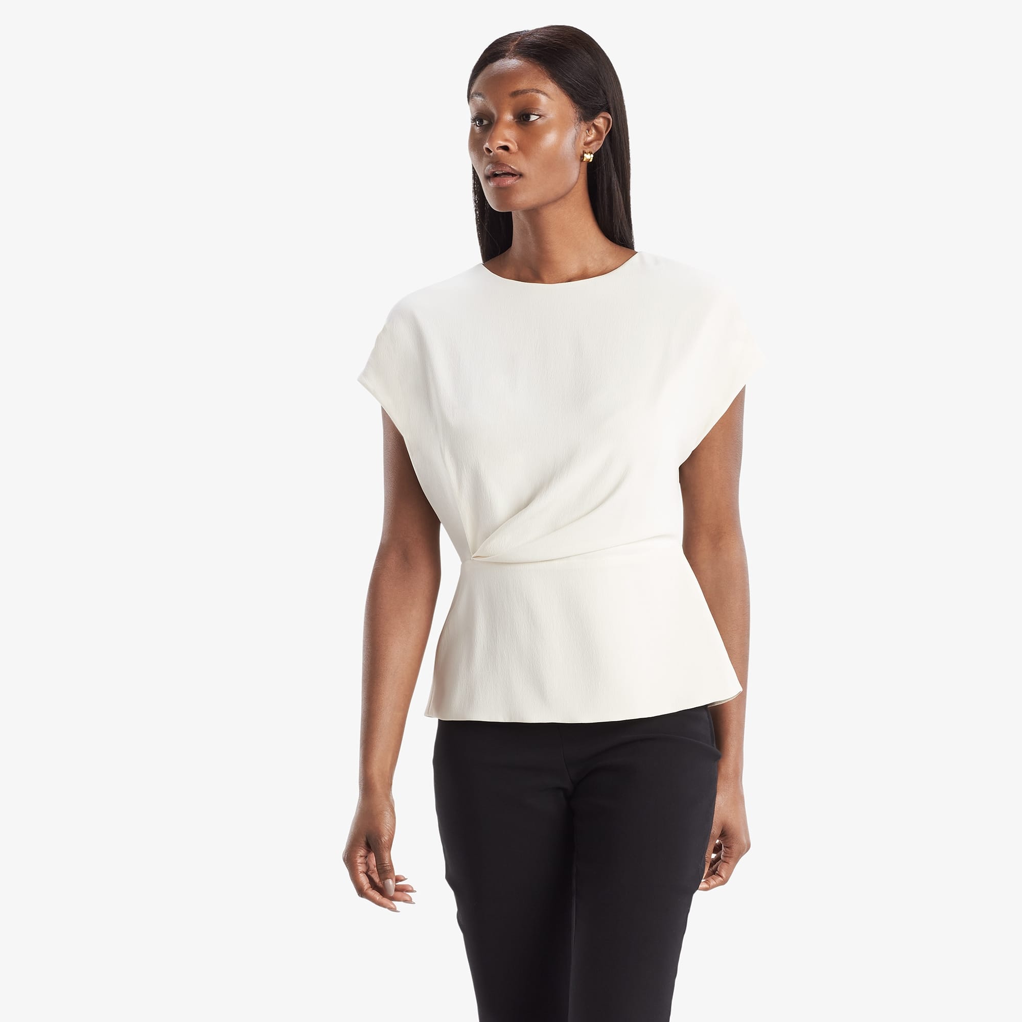 Front image of a woman standing wearing the Nejvi Top in alabaster | Exclude
