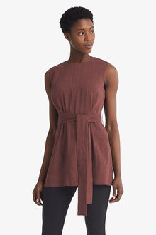 Front image of a woman standing wearing the Angelina top stretch linen in sumac | Grid | Exclude