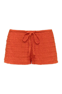 Tangerine textured shorts with drawstring waist and rolled cuffs.