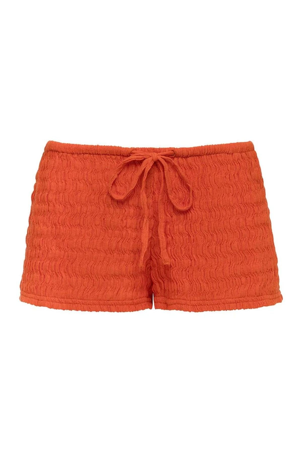 Tangerine textured shorts with drawstring waist and rolled cuffs.