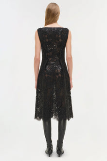 Black sequin lace sleeveless midi dress with irregular hemline, worn with black boots.