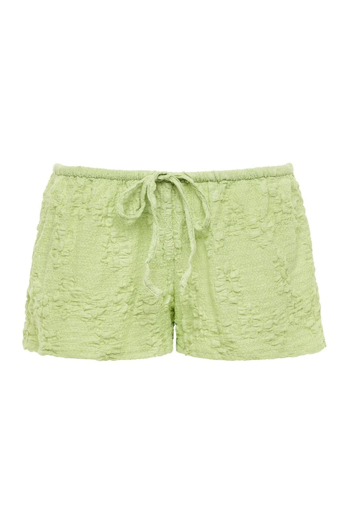 Pale green textured shorts with drawstring waist and floral quilted pattern throughout.