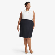 Front image of a woman standing wearing the Walters top knit crepe in Ivory