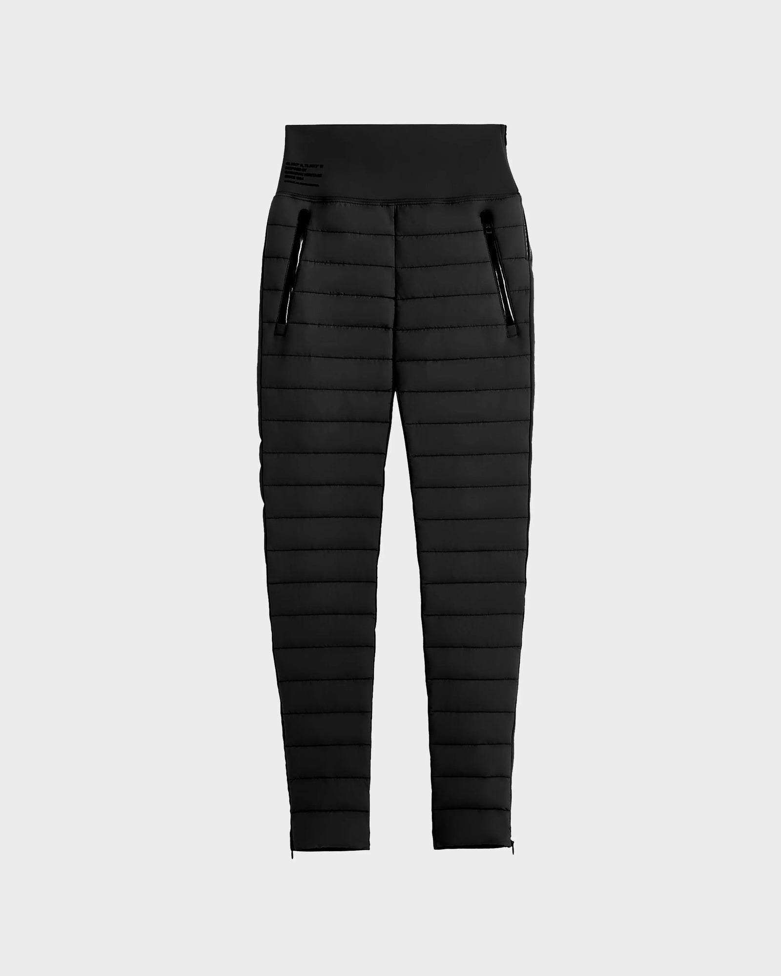 Rudsaks ARIL M - 8522514 BLACK womens quilted pants feature a slim fit, elastic waistband, and two front zippered pockets. These sustainable insulated après-ski chic pants are shown on a plain light gray background.