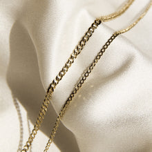 Flatlay Model. Close up of two chain necklaces on neutral background