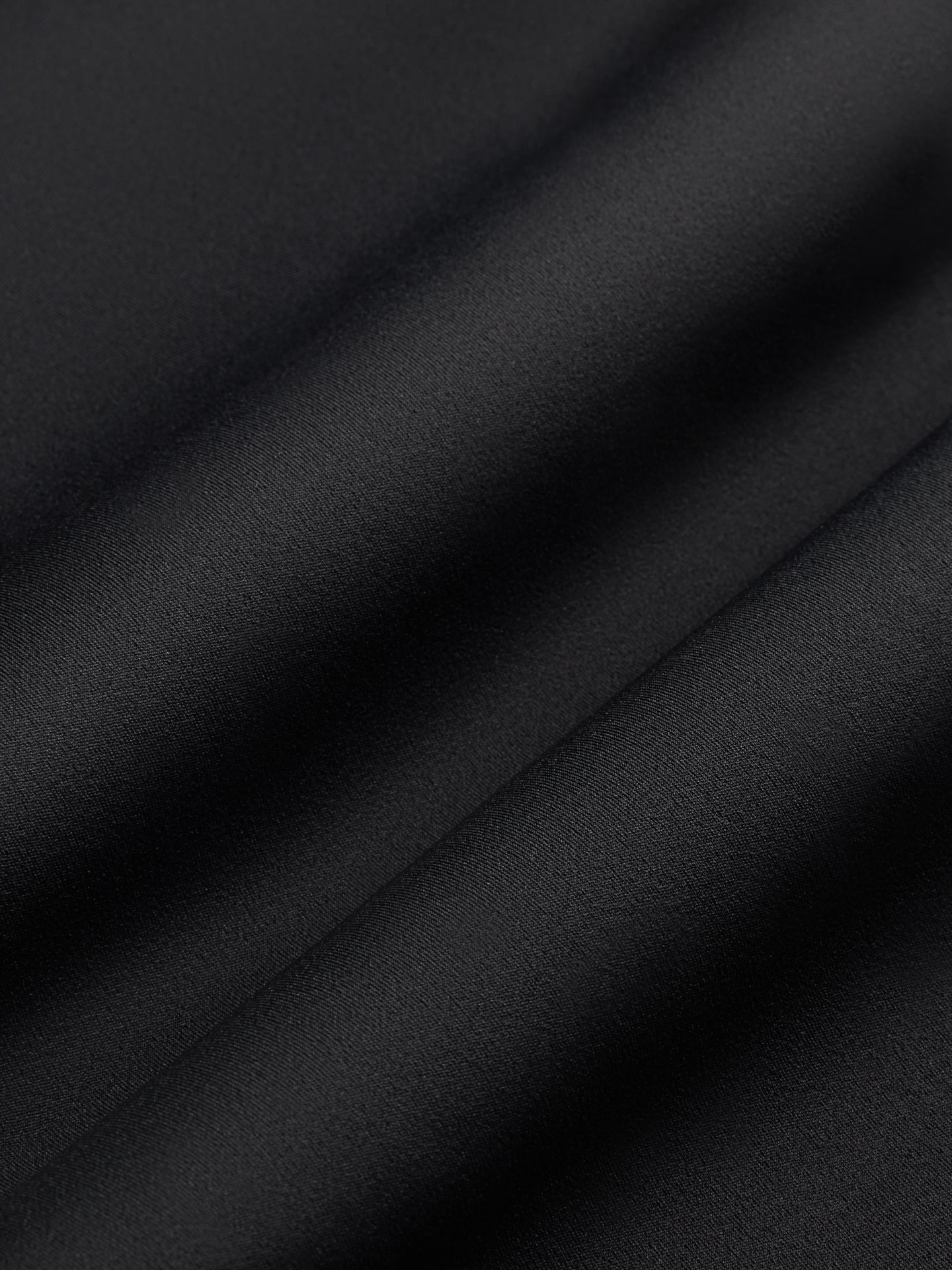 Close-up of Diamond Compression fabric in black showing smooth sculpting texture.