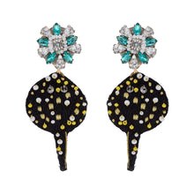 Black and Yellow Embroidered Sting Ray with Blue and Clear Crystal Topper on Flat White Background