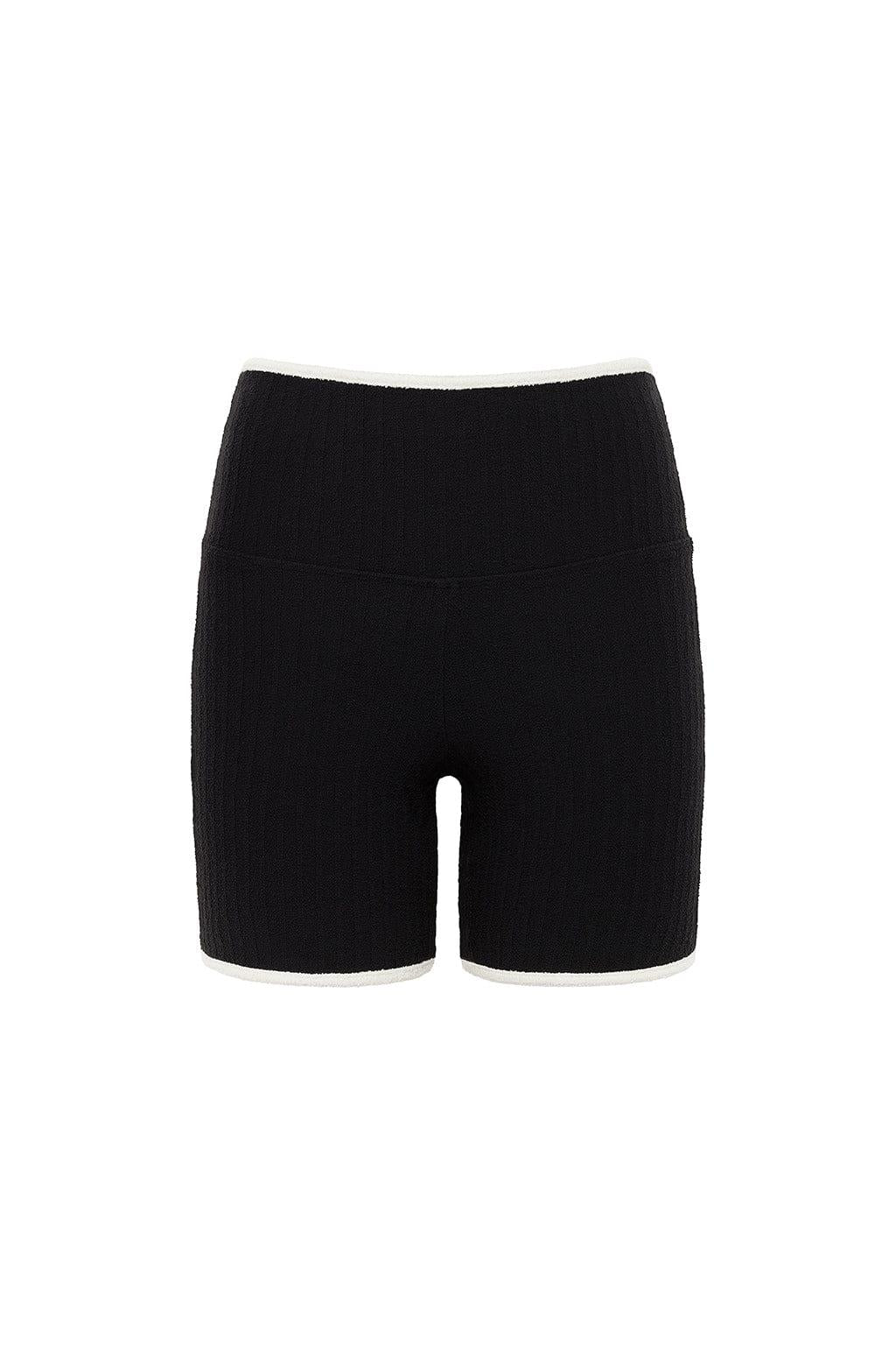 Black terry rib midi bike short with cream-colored binding at the waistband and leg openings.