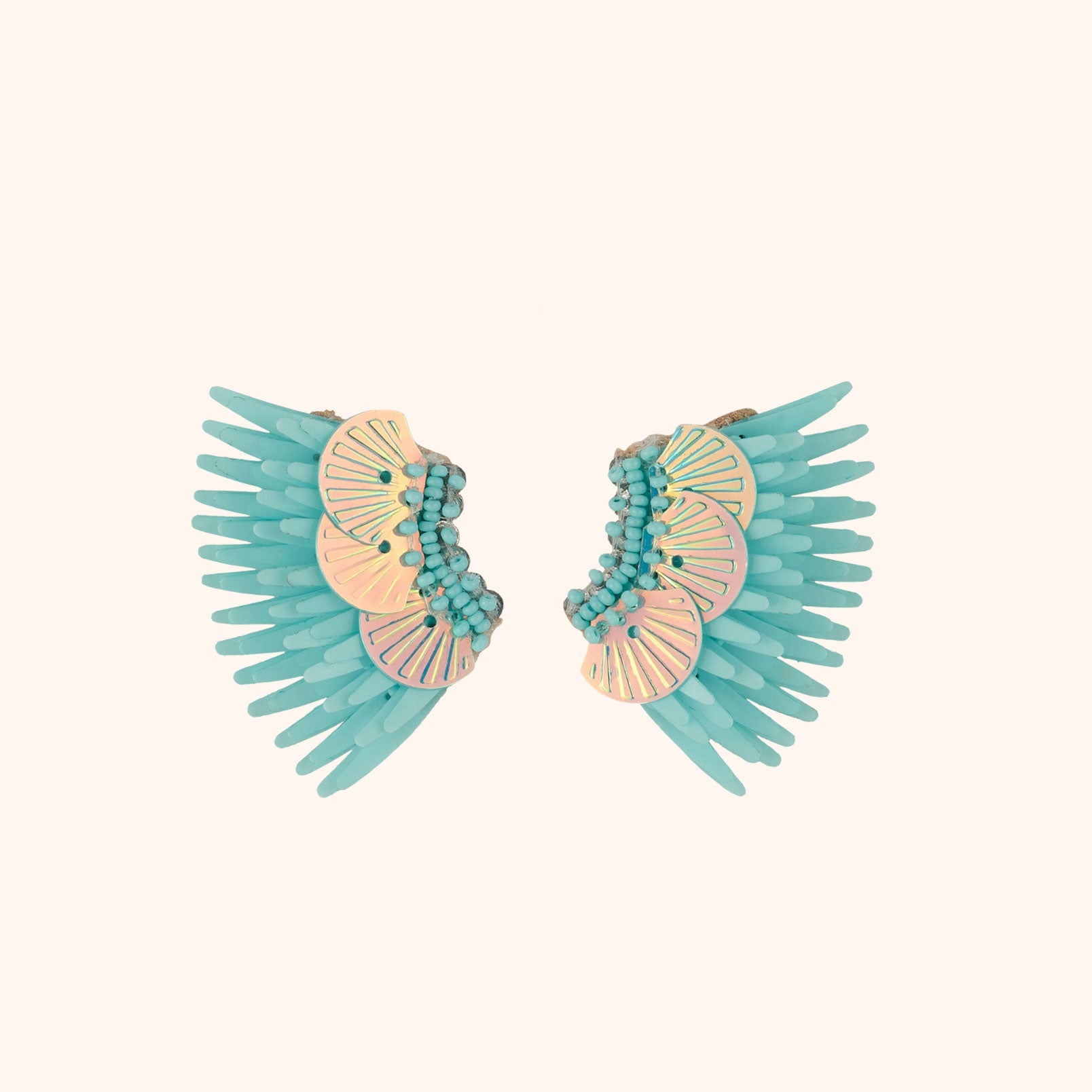 Turquoise and Iridescent Sequin Wing Earrings on Tan Background