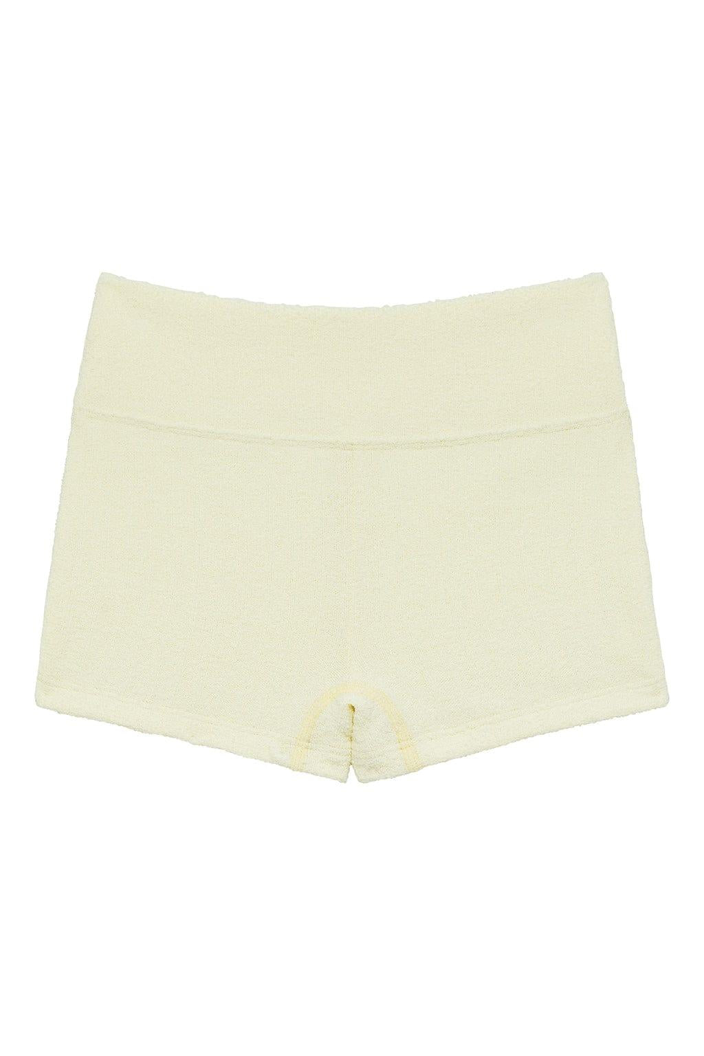 Cream-colored ribbed mini bike short with high waistband and visible seam detail at center front.