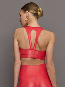 Model wears a v neck bright red bra in a liquidy takara shine finish. 