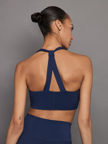 Back view of navy sports bra with racerback straps.