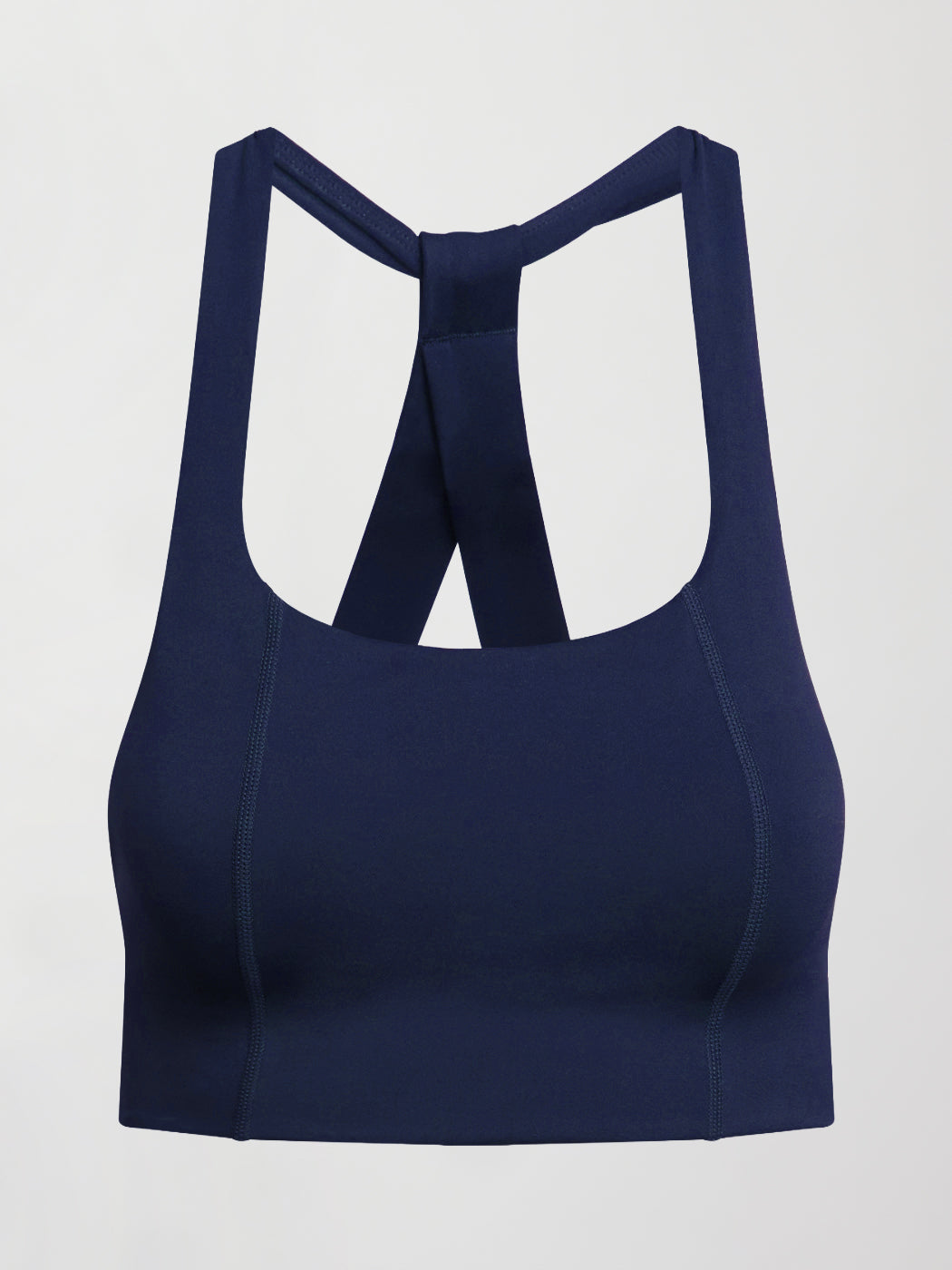 Flat lay of navy compression T Back sports bra on white background.