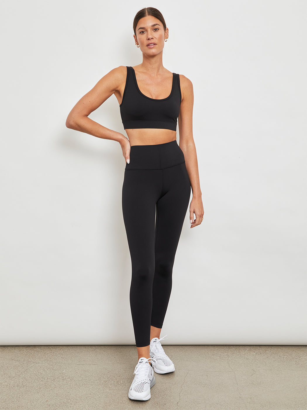 Full front view of black scoop bra styled with matching high-waisted leggings.