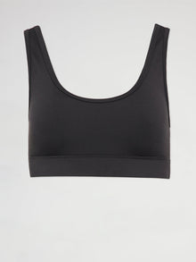 Flat lay of black scoop neck sports bra with cut out back design.