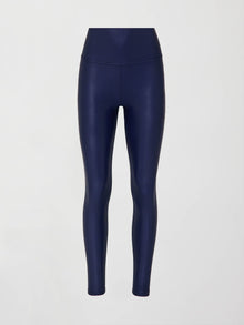 A pair of navy high waisted performance leggings in a liquidy-shine finish that hit at the ankle against a white background.