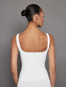 Back view of white ribbed tank showing scoop neckline.