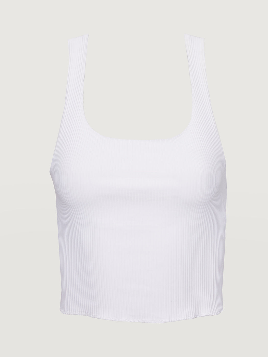 Flat lay of white ribbed cropped tank on neutral background.