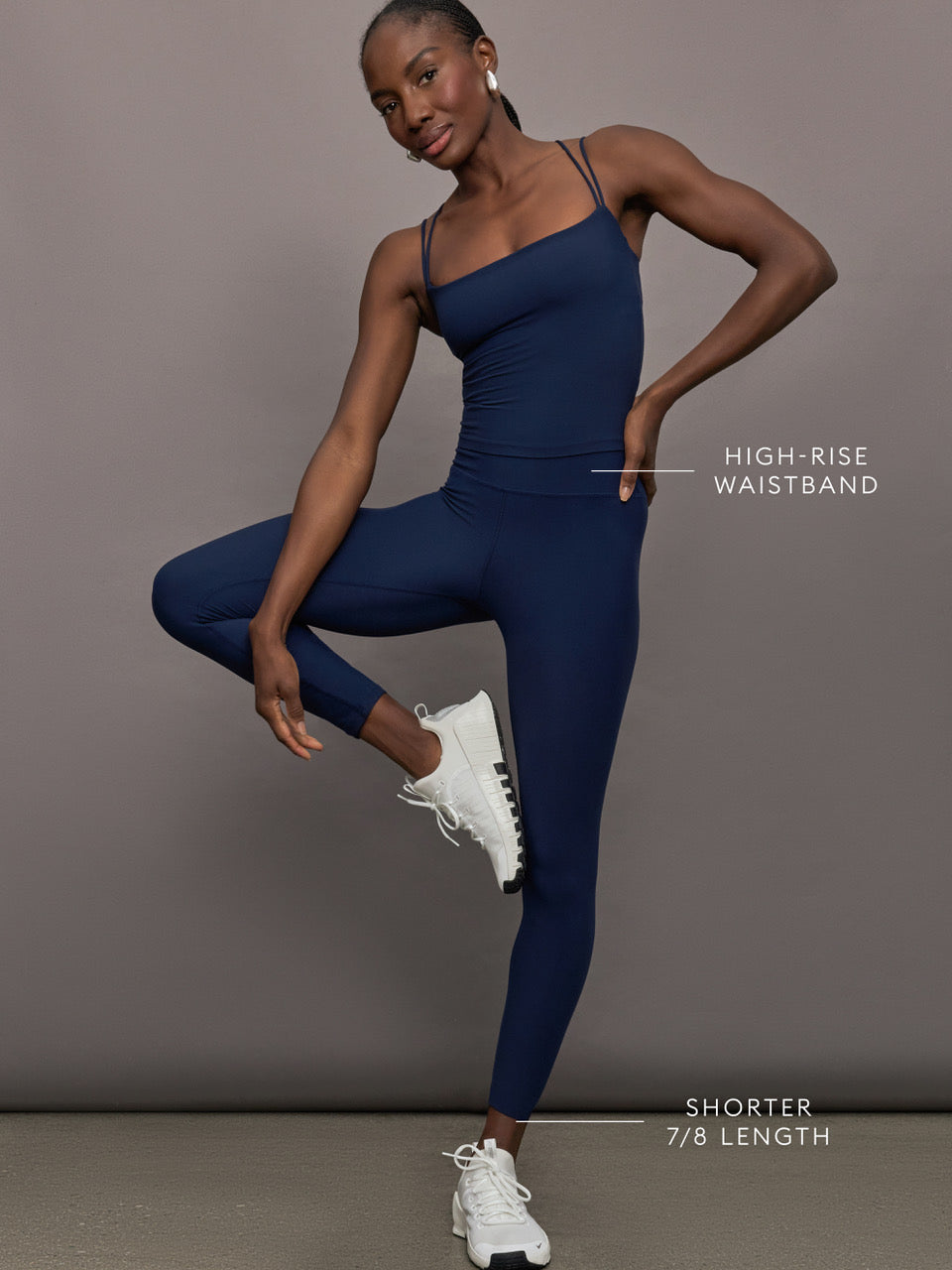 Model wears navy high-rise, full-length leggings with a matte finish and a smooth, body-hugging fit.

