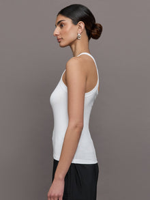 Model wears a white ribbed one shoulder tank.