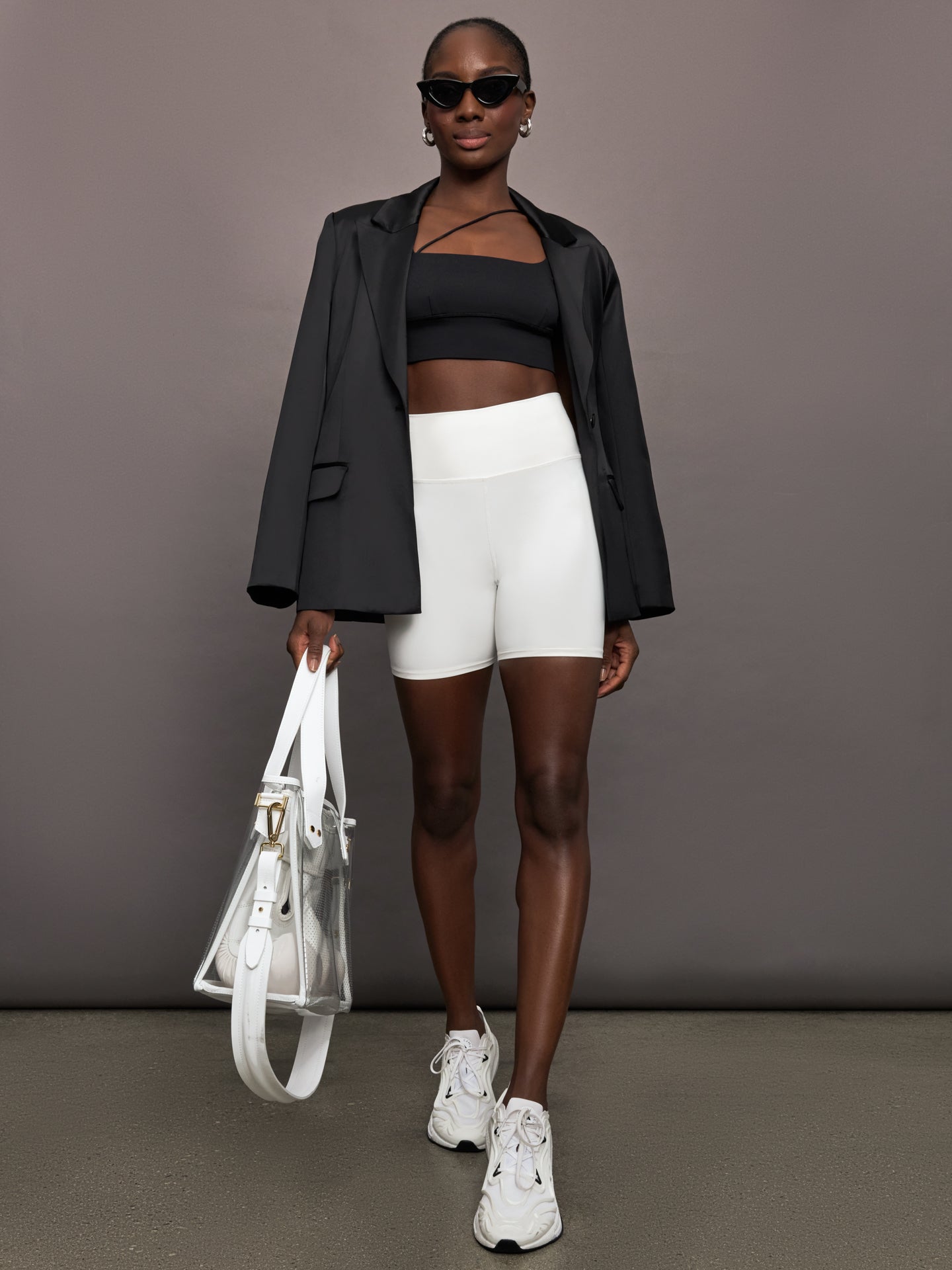 Model wears a black satin single breasted blazer. 