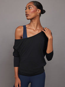 Front view of model wearing Long Sleeve Off Shoulder Tee Black with relaxed neckline.