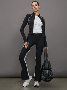 Model wears white short sleeve T-shirt with ruching down the center of the chest until the belly button. 