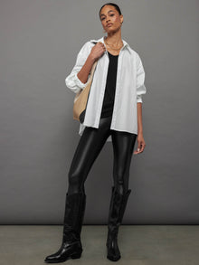 Model wears a black, short sleeve crewneck t-shirt with a front pocket and a relaxed, hip-length fit.
