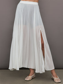 Front view of model wearing Mesh Pleated Skirt Ivory with side slit detail.