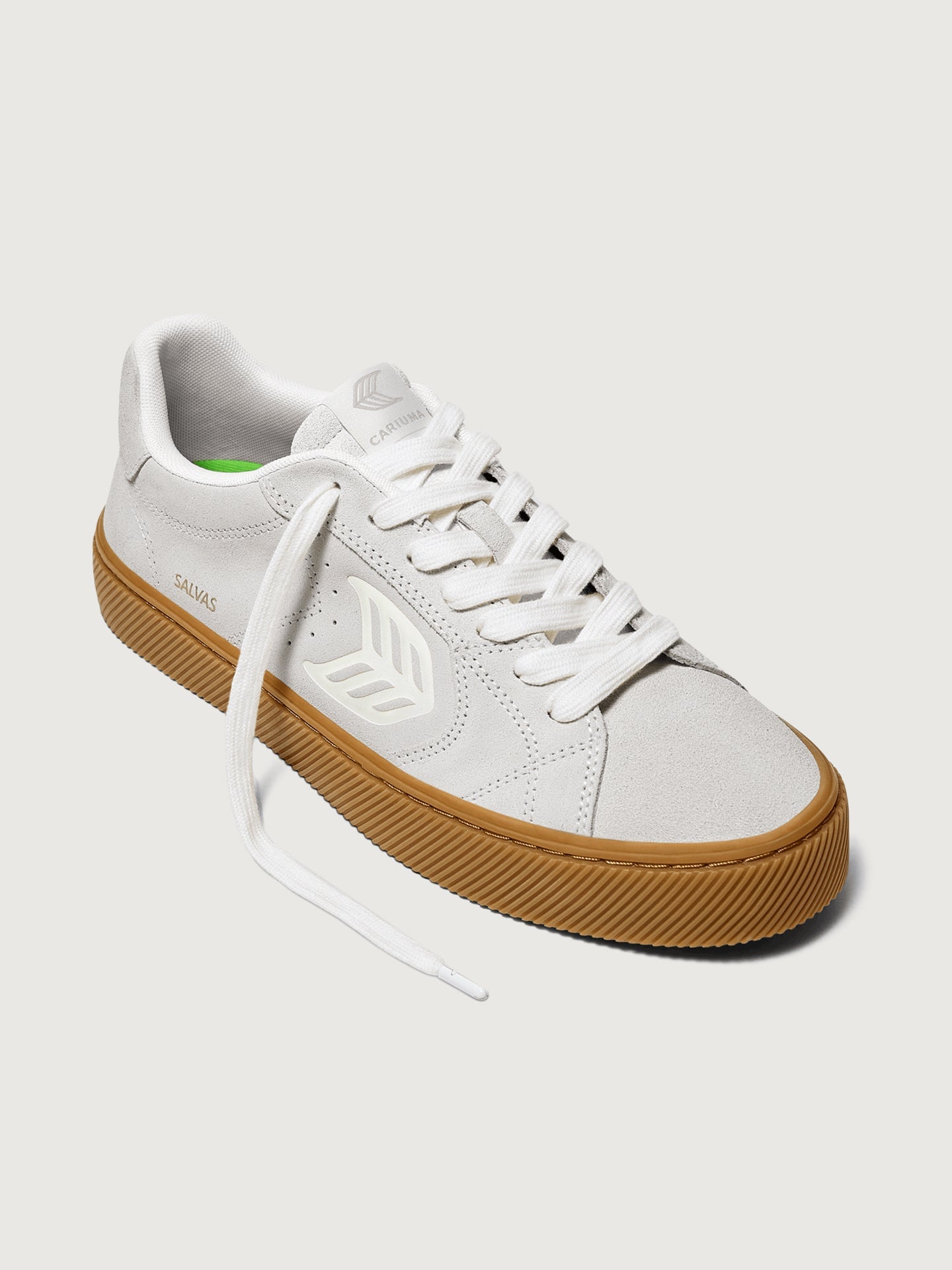 Suede white/light gray sneaker with light brown sole. 