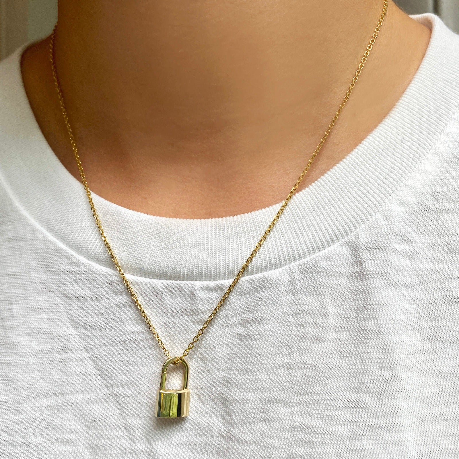 14k gold Diamond Cut Cable Chain Necklace. Styled on a neck with a padlock charm