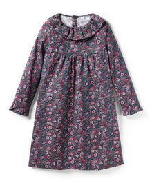 The Girl's Twill Scarlett Nightgown in Fleurs de Saison is a long-sleeved, knee-length dress with a ruffled collar and cuffs, featuring pink and white flowers with green leaves on a dark background.