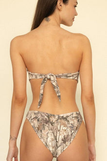Camo print bandeau bikini top with tie closure at back, shown from behind on model.
