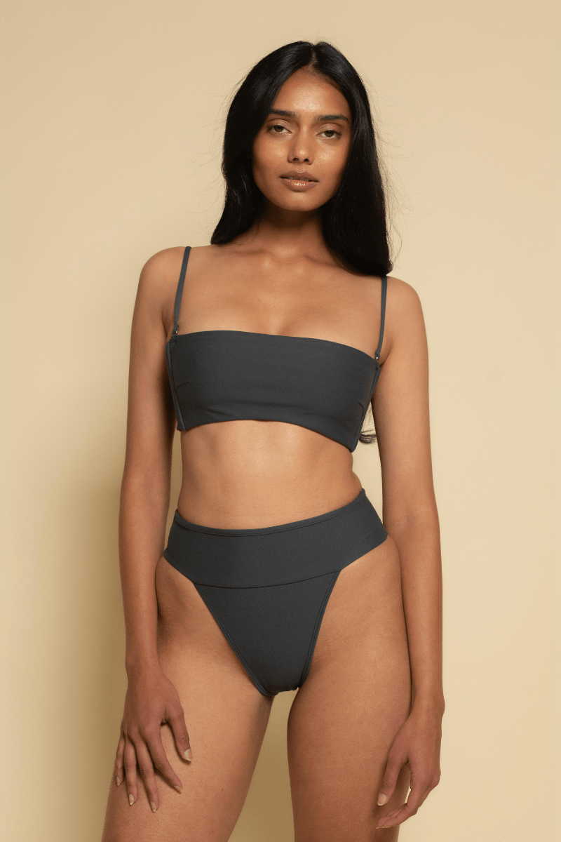 Charcoal bikini bottom with high-waisted cut and contrasting trim detail worn with matching bandeau top.