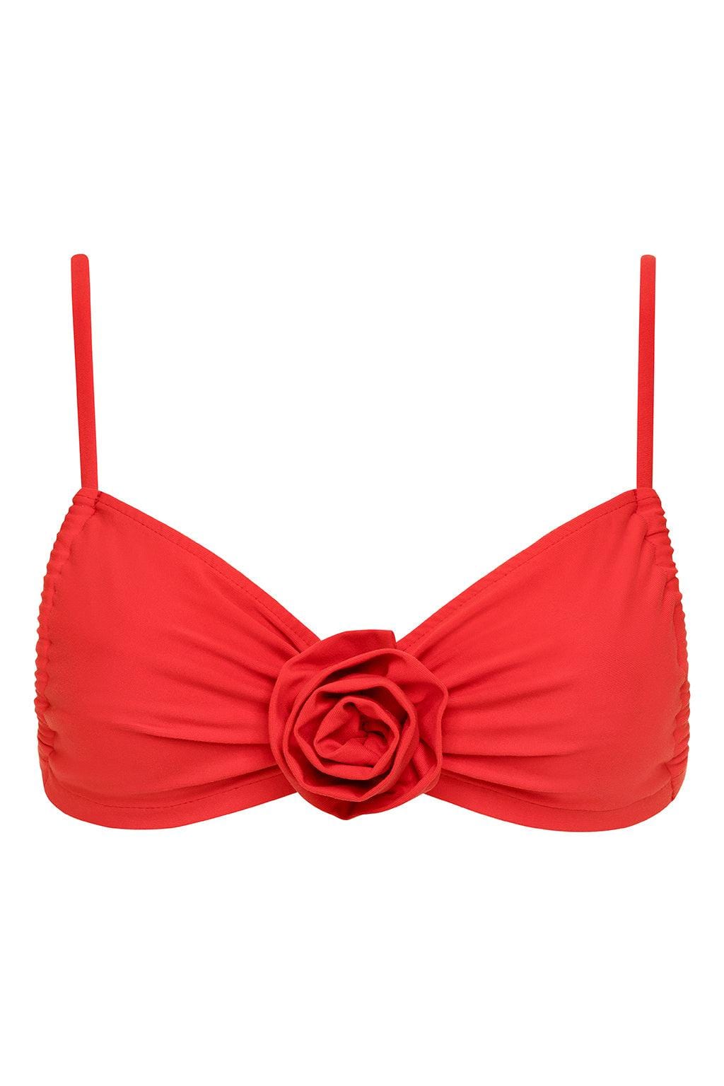 Red bikini top with ruched fabric, thin shoulder straps, and a three-dimensional rose flower detail at the center front.