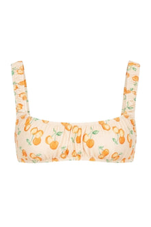 Cream bikini top with orange and cherry print, square neckline, and adjustable shoulder straps.